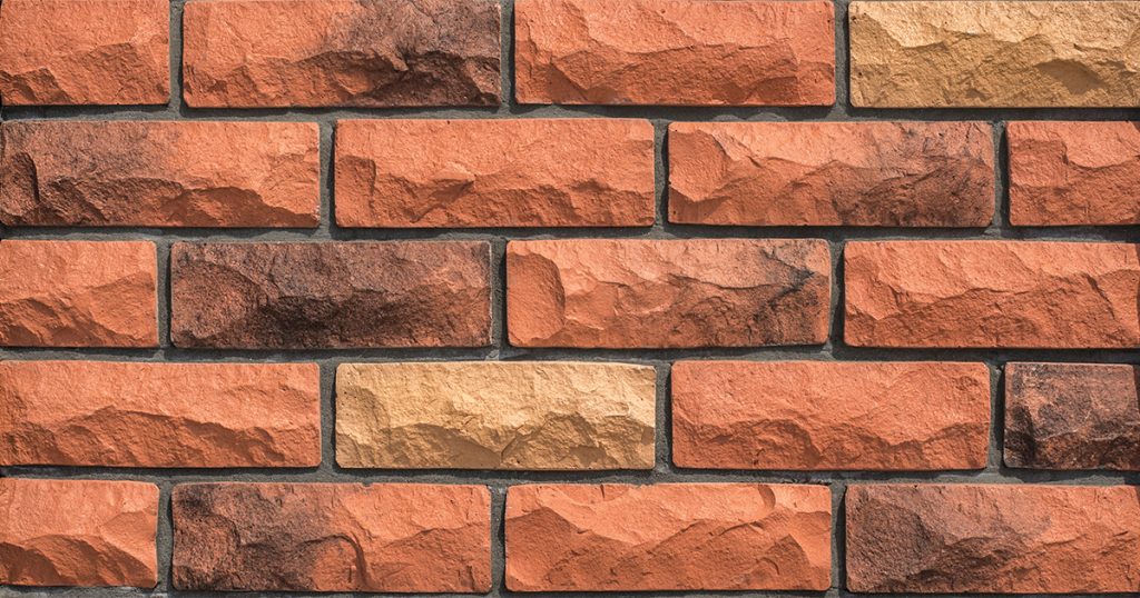 Rock Face Brick RFB 728 in orange-red, mustard, and soot accents